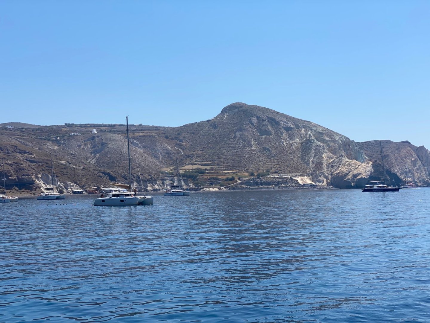 Boats from day trips at Mesa Pigadia beach Santorini
