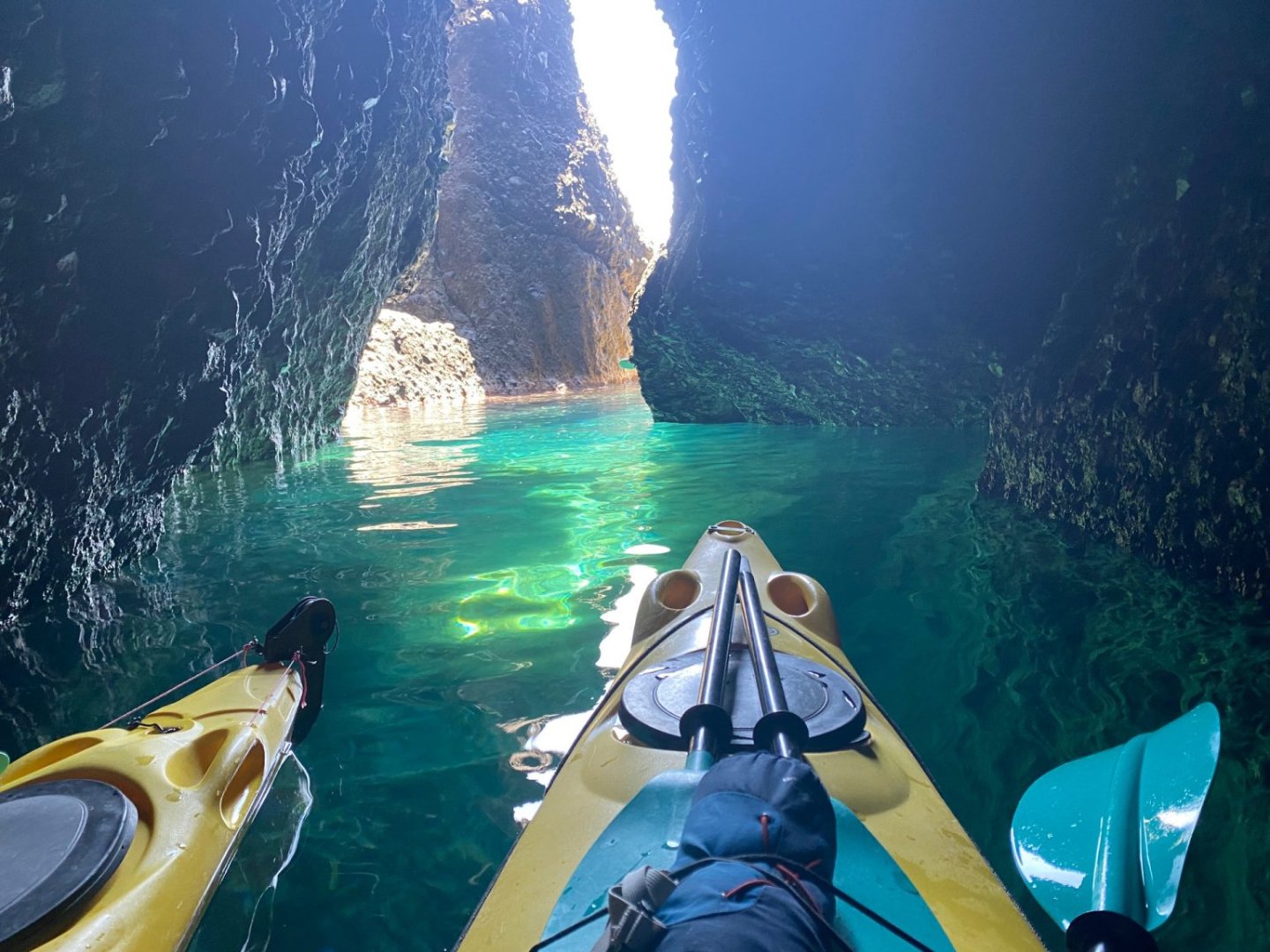 Kayaking in Santorini sea cave and front of kayaks