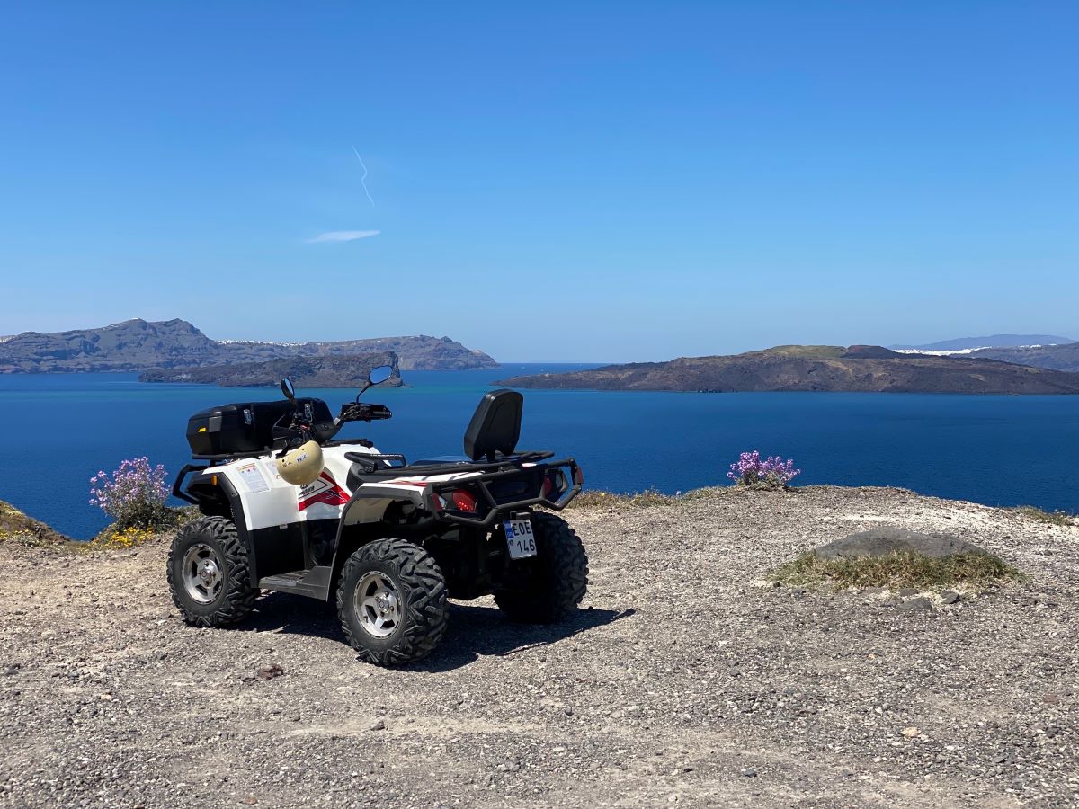 An ATV overlooking the sea, Oia and Thirassia island