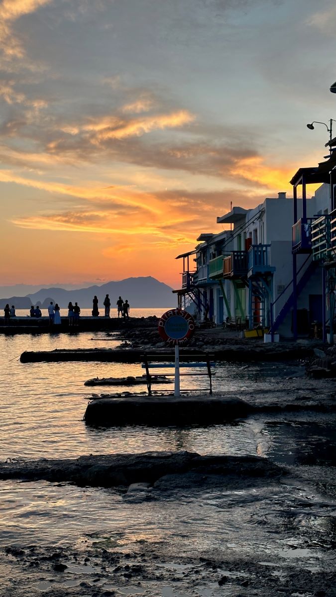 Klima at sunset with people standing watching the sky