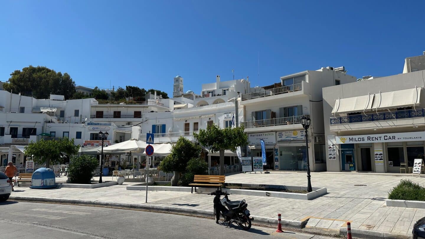 White buildings with shops and airbnbs at Adamas Port Milos