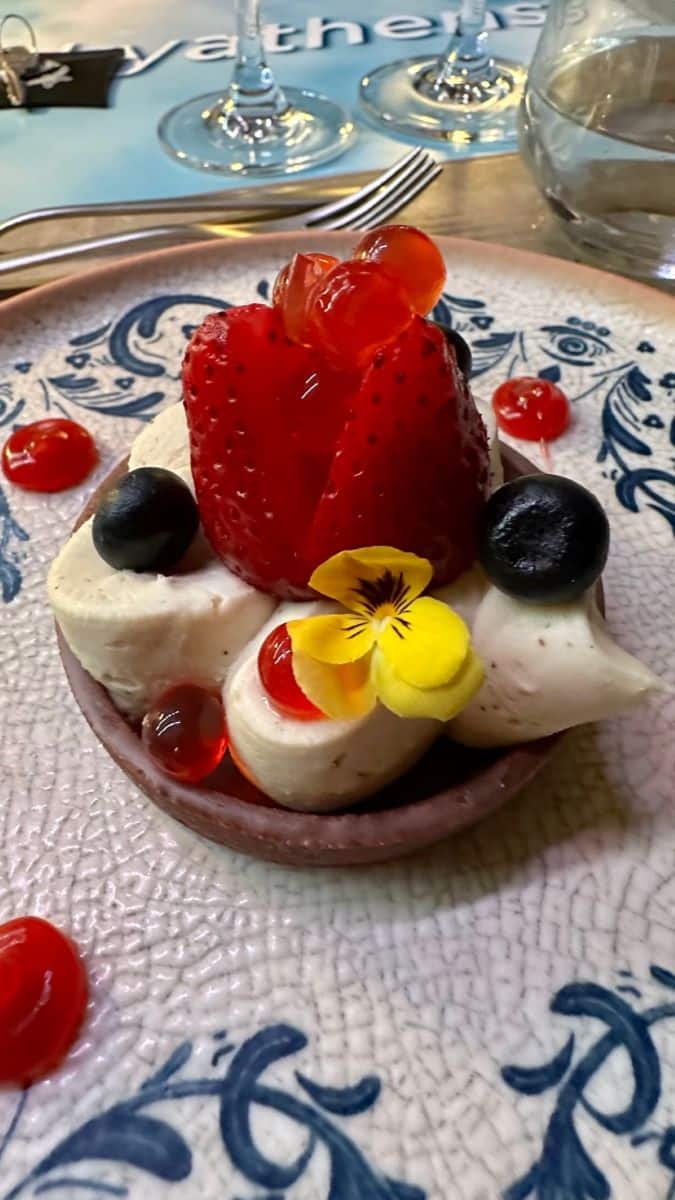 Chocolate tart desert with strawberry and edible flower
