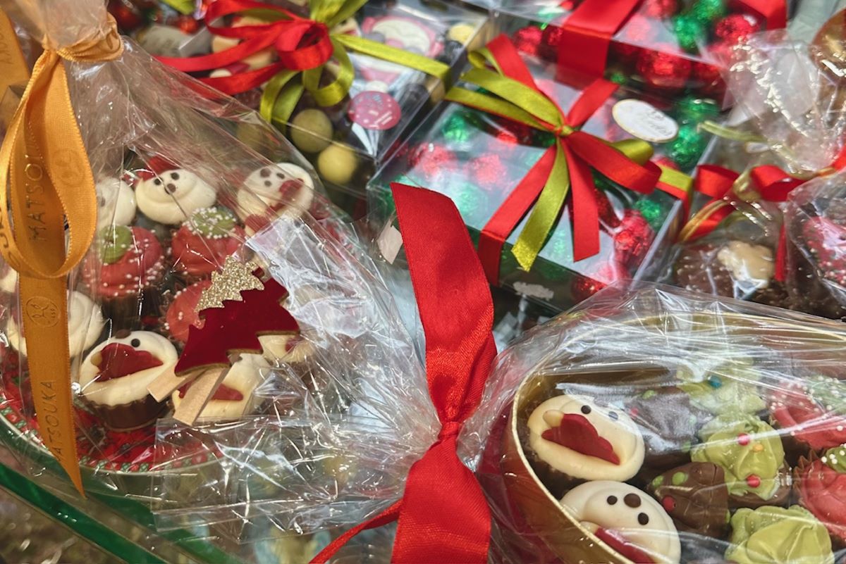 Packages of Christmas chocolates decorated in a shop window.