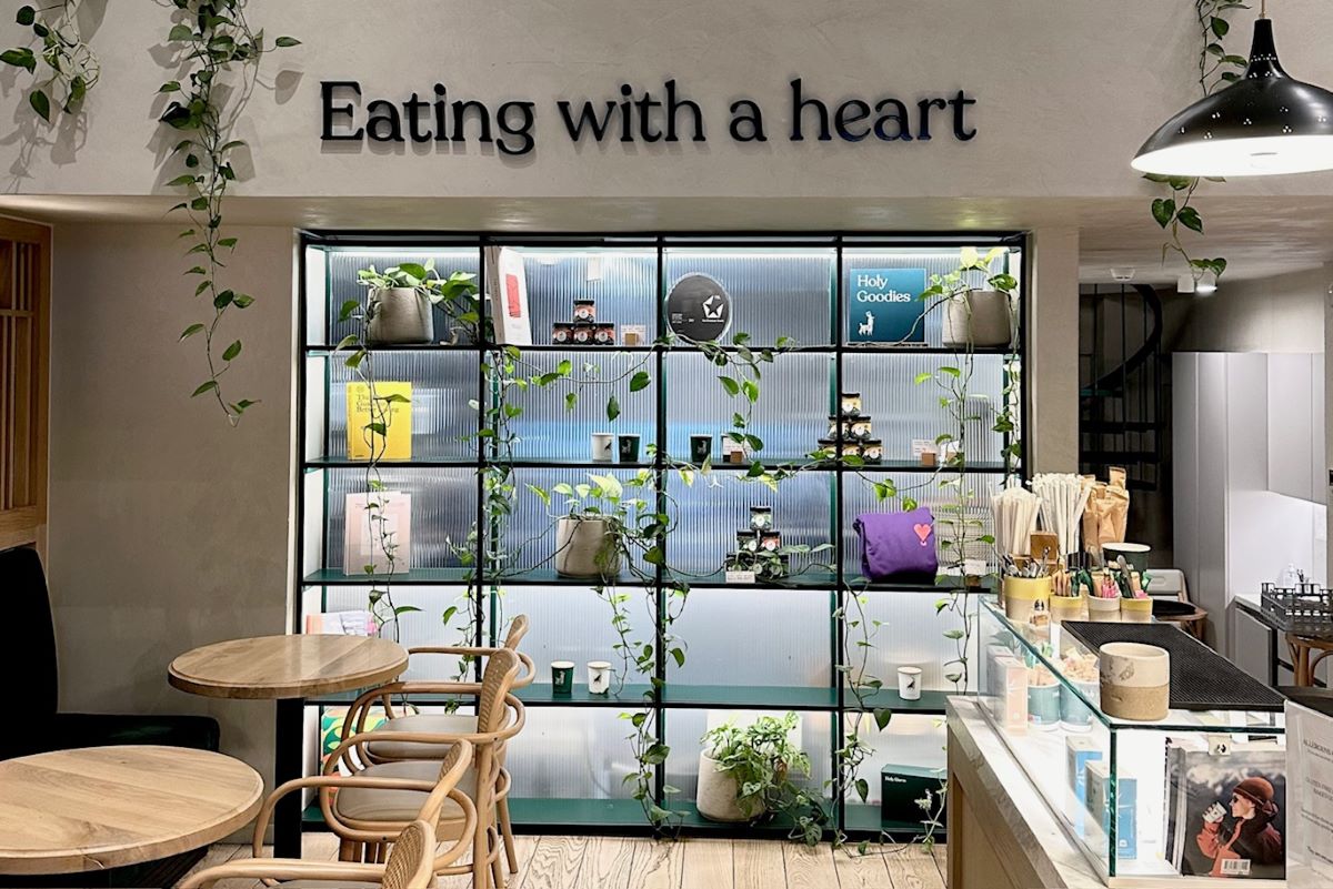 Eating with heart written on wall at the indoor seating area of the vegan bakery in Athens